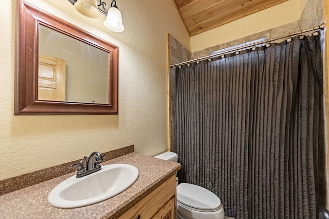 bathroom featuring a textured wall, toilet, lofted ceiling, wood ceiling, and vanity