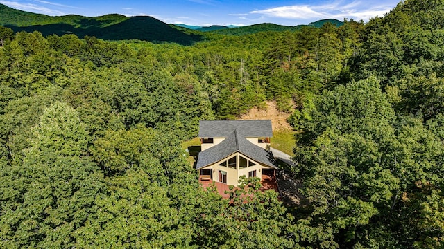 drone / aerial view with a forest view and a mountain view