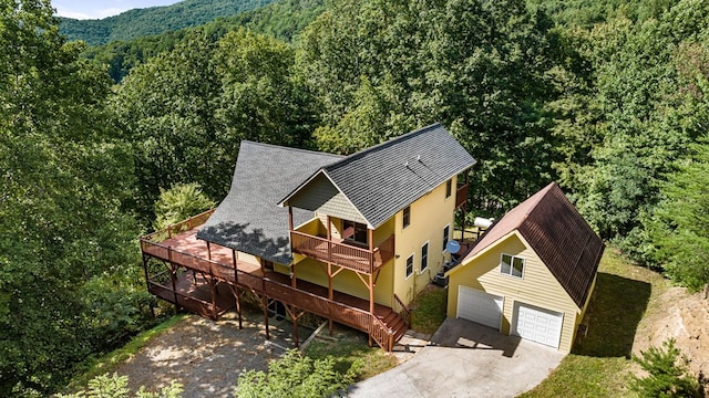 birds eye view of property featuring a view of trees