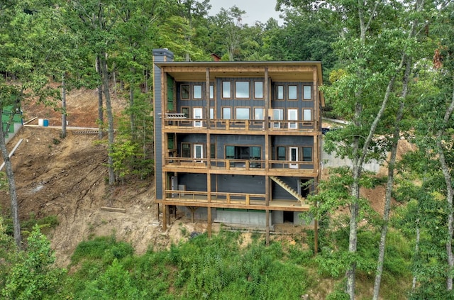 back of house featuring a balcony