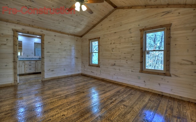 empty room with vaulted ceiling, hardwood / wood-style flooring, plenty of natural light, and wooden ceiling