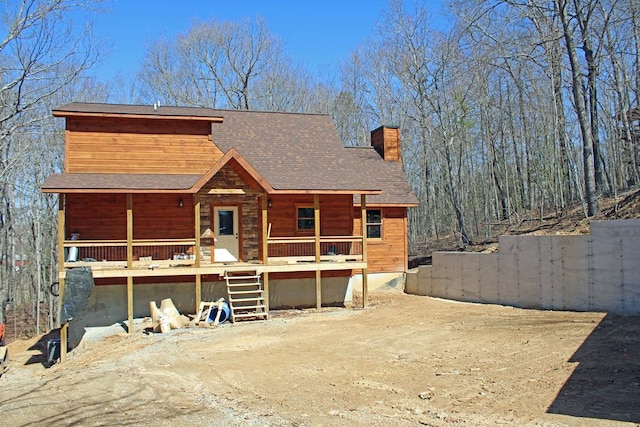 view of front of home featuring a chimney and fence