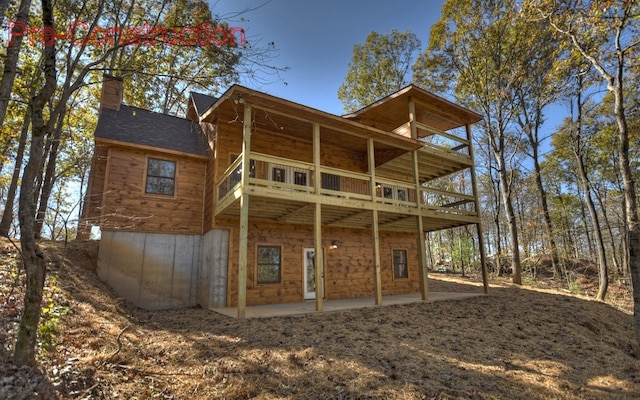 rear view of house with a patio area and a chimney