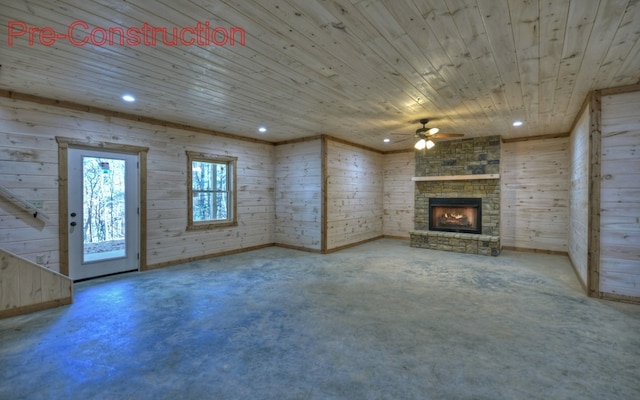 unfurnished living room with a stone fireplace, recessed lighting, wood ceiling, and concrete flooring