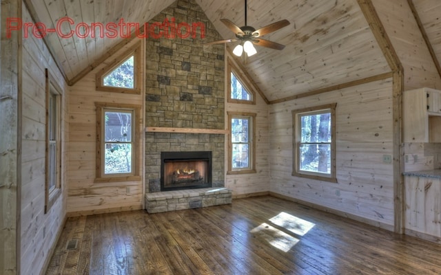 unfurnished living room with hardwood / wood-style flooring, wooden walls, wood ceiling, and visible vents