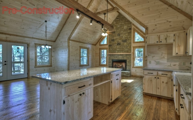 kitchen with dark wood-style floors, a kitchen island, light brown cabinetry, wood ceiling, and wood walls