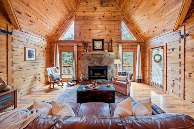 living room with wood ceiling, wood walls, and a healthy amount of sunlight