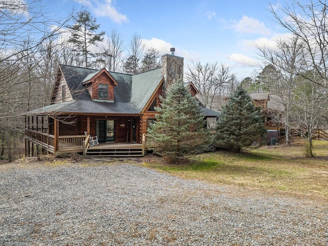 log-style house featuring a porch