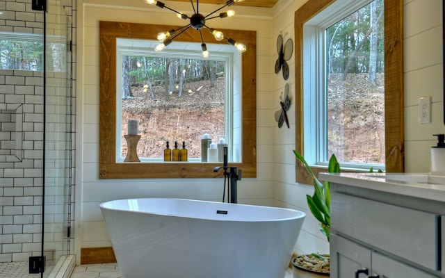 bathroom with vanity, a wealth of natural light, and independent shower and bath