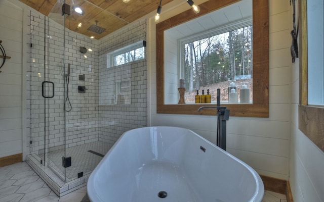 bathroom featuring plus walk in shower, tile patterned flooring, ceiling fan, and wooden ceiling