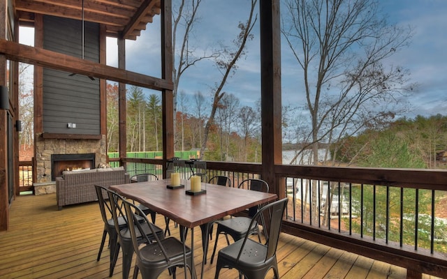 deck with an outdoor stone fireplace