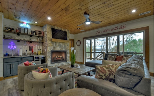 living room with plenty of natural light, ceiling fan, and wooden ceiling