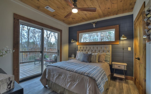 bedroom featuring hardwood / wood-style floors, crown molding, access to exterior, ceiling fan, and wooden ceiling