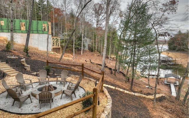 view of yard featuring a water view and a fire pit