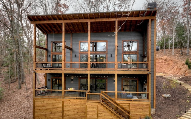 back of house featuring a wooden deck