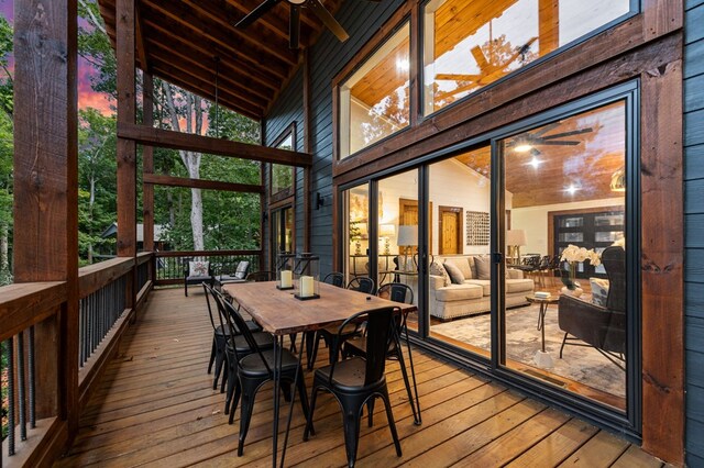 sunroom / solarium with lofted ceiling, ceiling fan, and wood ceiling