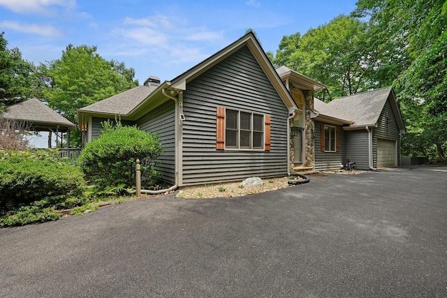 159 Cinnamon Fern Ln, Big Canoe, GA 30143 - view of front facade with asphalt driveway, a garage, and a chimney