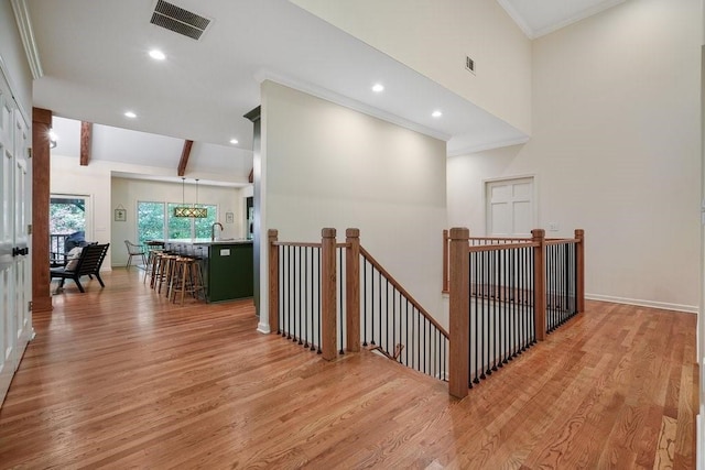 159 Cinnamon Fern Ln, Big Canoe, GA 30143 - corridor featuring an upstairs landing, light wood-type flooring, ornamental molding, high vaulted ceiling, and a sink