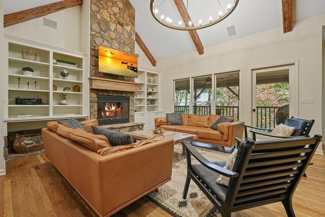159 Cinnamon Fern Ln, Big Canoe, GA 30143 - living area with a fireplace, beam ceiling, high vaulted ceiling, a chandelier, and wood finished floors