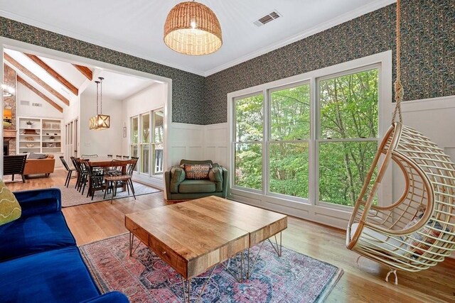 159 Cinnamon Fern Ln, Big Canoe, GA 30143 - living room featuring a chandelier, a wainscoted wall, wallpapered walls, wood finished floors, and ornamental molding