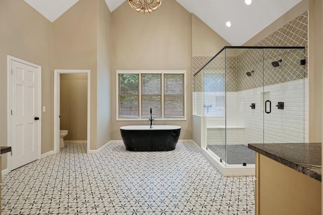 159 Cinnamon Fern Ln, Big Canoe, GA 30143 - full bath with high vaulted ceiling, a shower stall, a freestanding bath, toilet, and baseboards