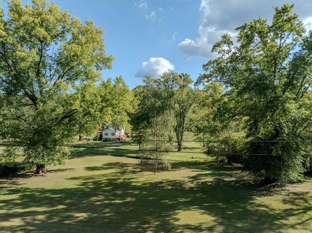 view of property's community with a lawn