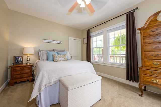 bedroom with light carpet, baseboards, and ceiling fan