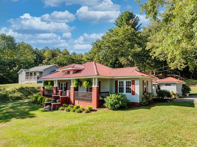 exterior space featuring metal roof, a front lawn, and a porch