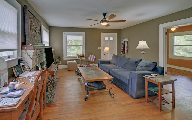 30 Proctor St, Murphy, NC 28906 - living area featuring healthy amount of natural light, a ceiling fan, wood finished floors, and a fireplace
