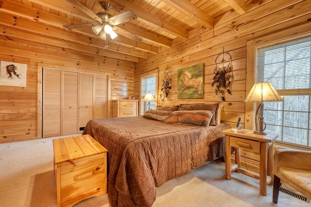 carpeted bedroom featuring wooden ceiling, wooden walls, and beam ceiling