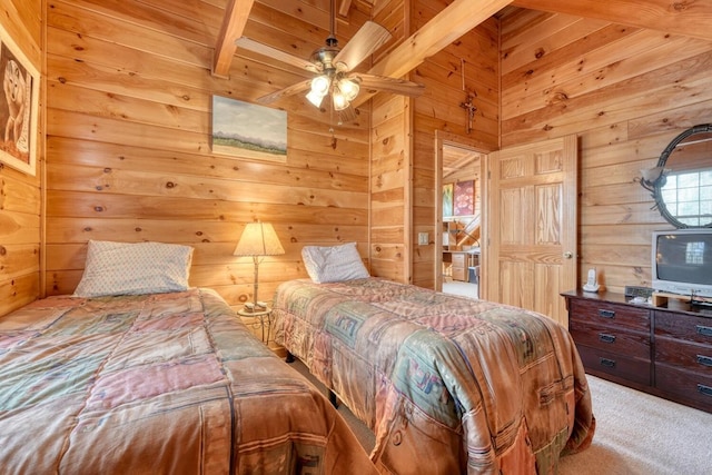 carpeted bedroom with beam ceiling, wood walls, and wooden ceiling