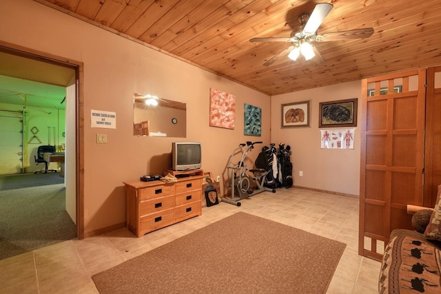 interior space featuring ceiling fan, light tile patterned floors, and wooden ceiling