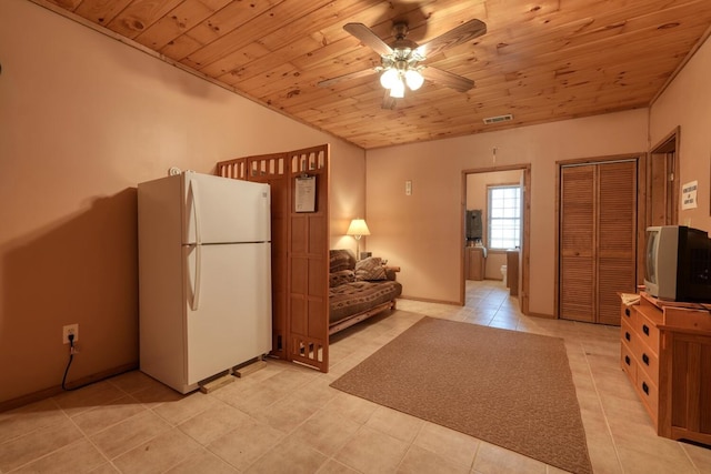 kitchen with vaulted ceiling, light tile patterned floors, white refrigerator, ceiling fan, and wood ceiling