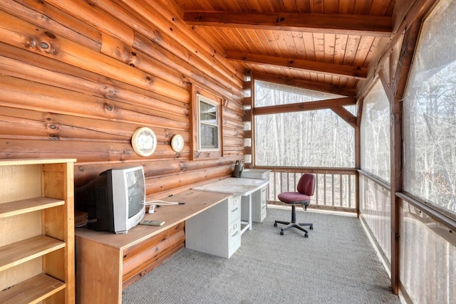 unfurnished office featuring carpet floors, lofted ceiling with beams, and a wealth of natural light