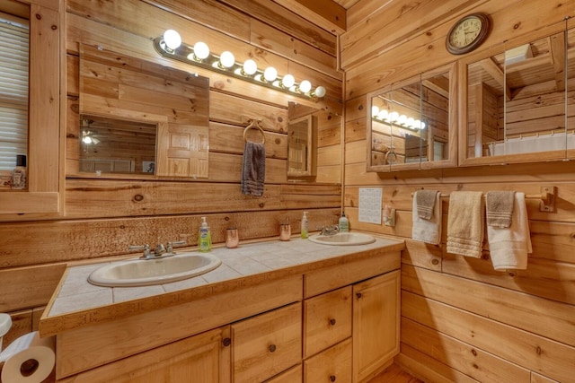 bathroom featuring vanity and wooden walls