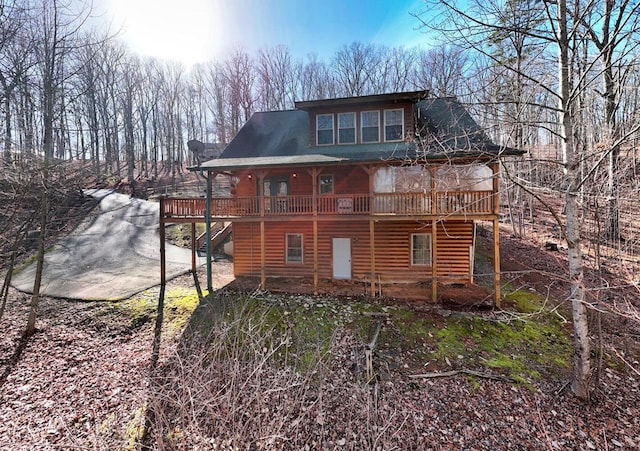 rear view of property featuring a wooden deck