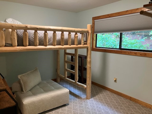 bedroom with baseboards and carpet