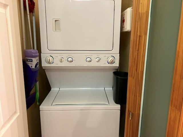clothes washing area featuring stacked washer / dryer