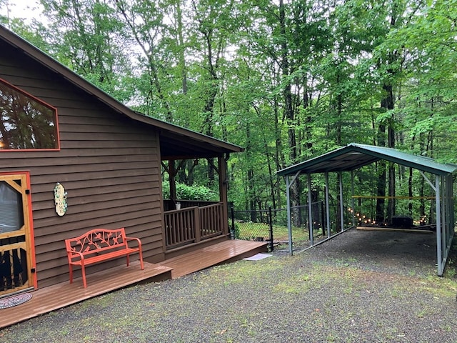view of yard with a detached carport and gravel driveway