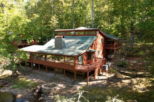 rear view of property featuring a water view and central air condition unit