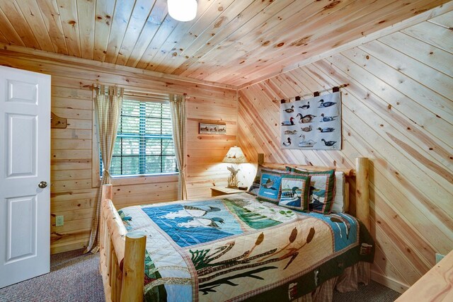 carpeted bedroom with wood walls and wooden ceiling