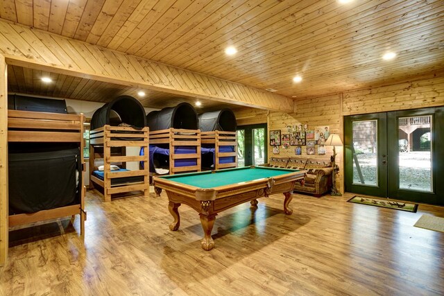 rec room with light hardwood / wood-style floors, wood ceiling, wood walls, and billiards