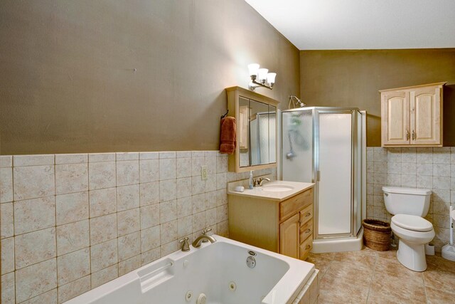 full bathroom featuring shower with separate bathtub, tile patterned floors, vanity, and toilet