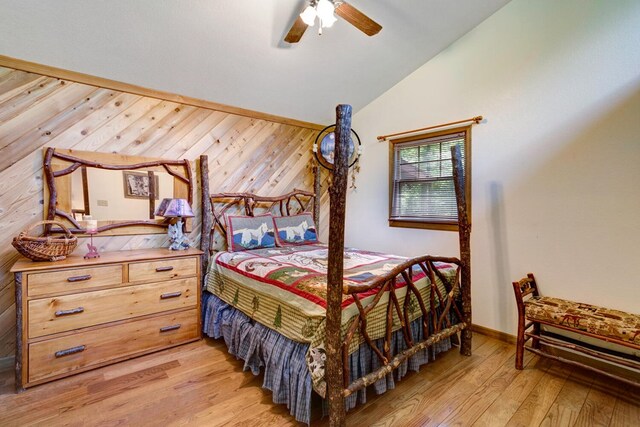 bedroom with light hardwood / wood-style floors, vaulted ceiling, and ceiling fan