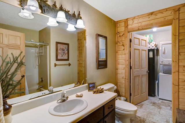 full bathroom with vanity, wooden walls, shower / bath combo with shower curtain, stacked washer / dryer, and toilet