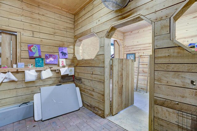 interior space featuring wooden walls