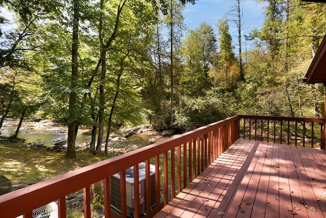 wooden terrace with cooling unit and a water view