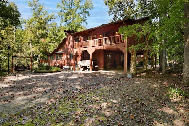 rear view of house featuring a deck