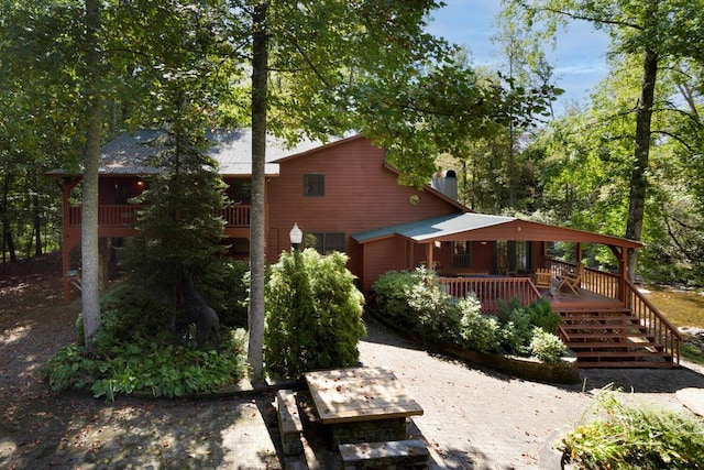 rear view of property featuring a deck