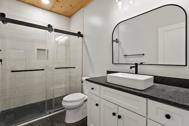 bathroom featuring wood ceiling, vanity, wood-type flooring, a shower with shower door, and toilet